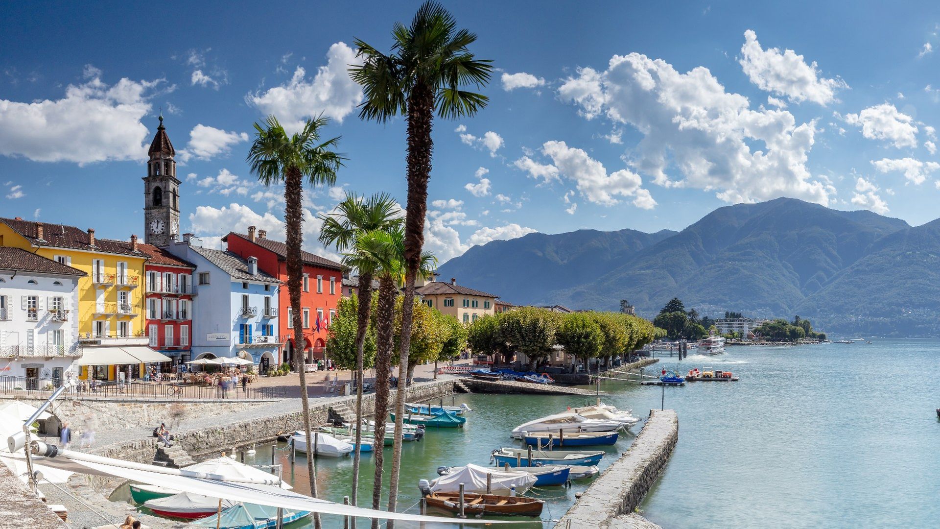 The waterfront of Ticino, with historic buildings, lake and mountains